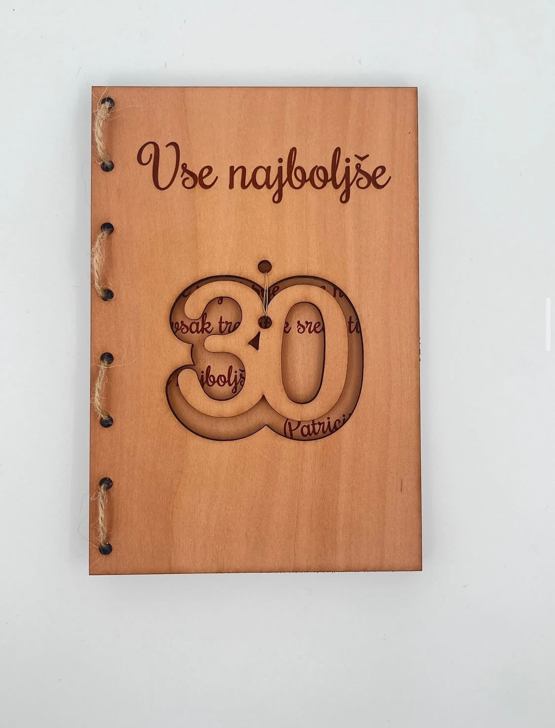 Lesena voščilnica s plapojočo številko v sredini.